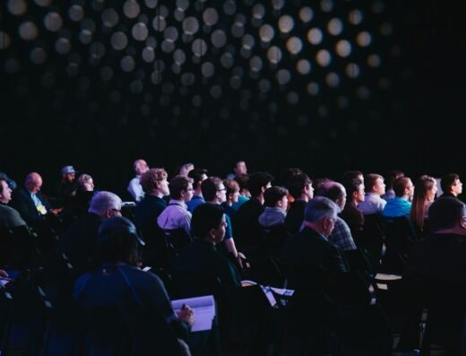 An audience listening to a speaker at a professional conference