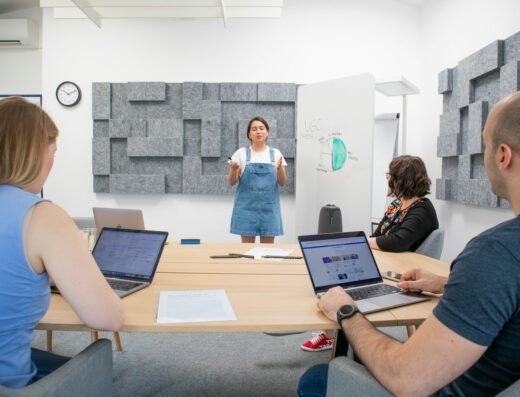 Professional presenting visual content to a team in a meeting room