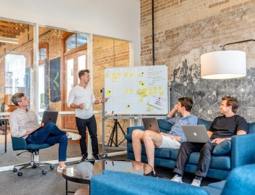Project team planning work together at a whiteboard